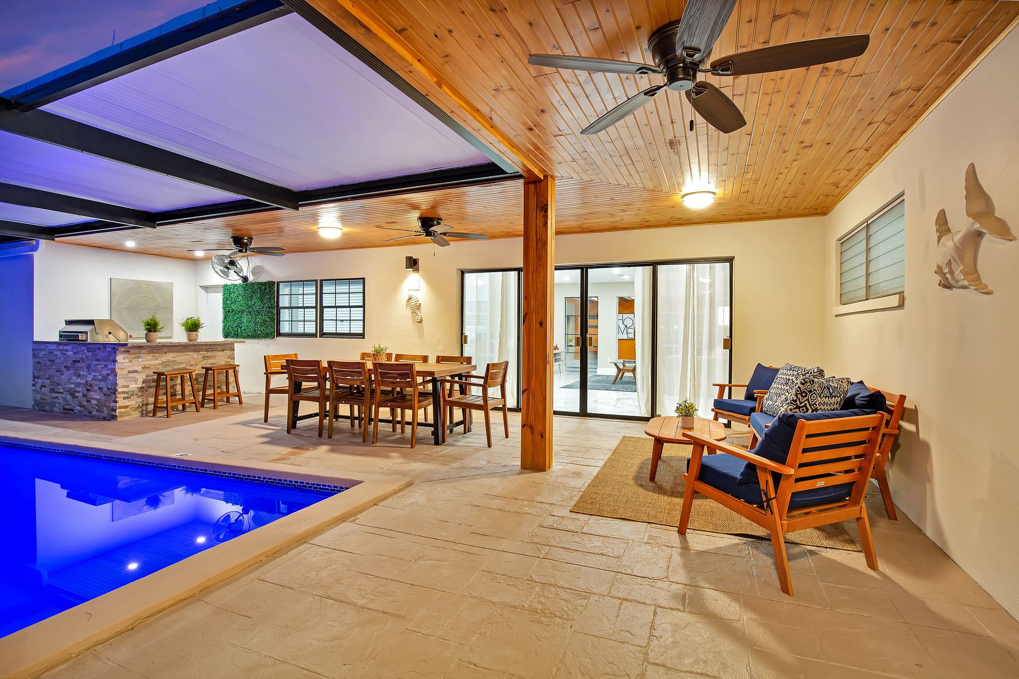 StayRnR-managed covered patio with pool, outdoor bar, and dining area