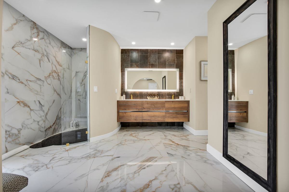 Renovated bathroom with book-matched marble and walnut vanity